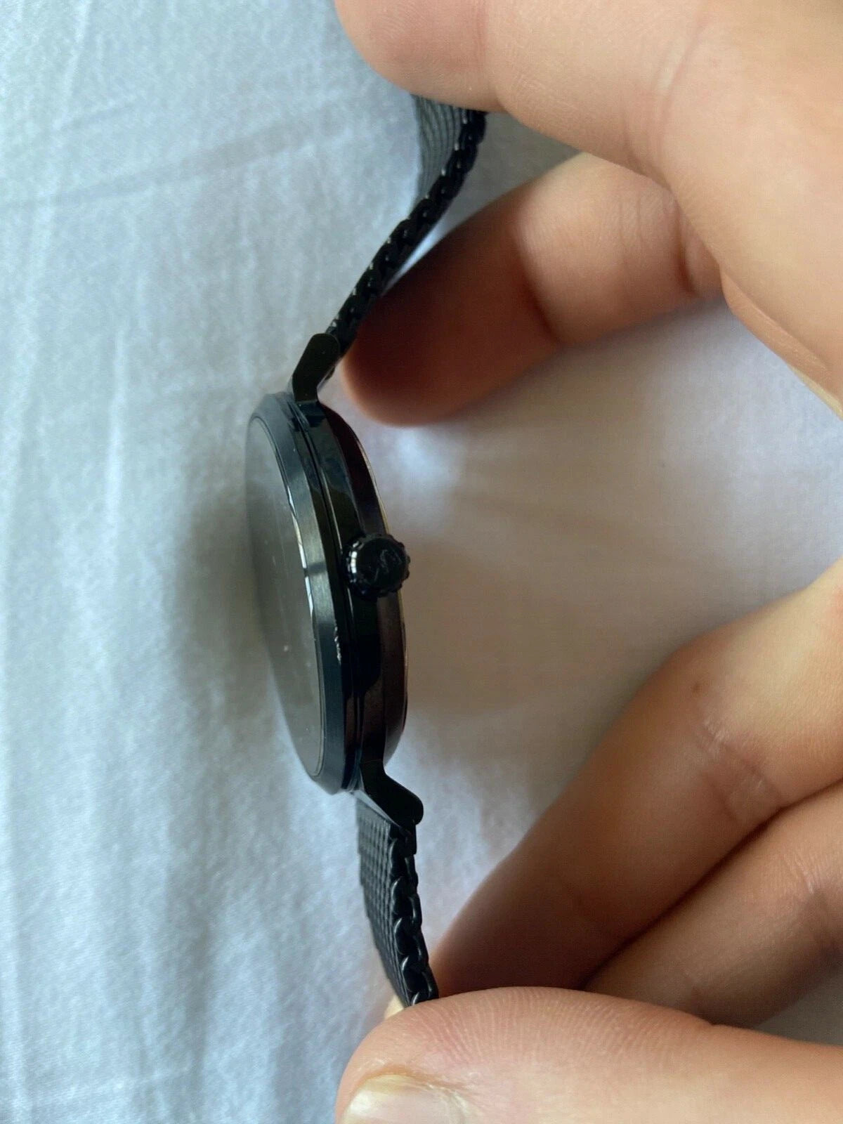 Close-up of Michael Kors MK8742 black analog dial with black Milanese mesh bracelet