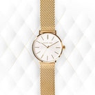 Close-up of Michael Kors MK7150 white analog dial with gold-tone indexes