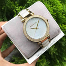 Close-up of Michael Kors MK6400 white analog dial with gold and white multi-link bracelet