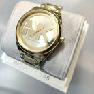 Close-up of Michael Kors MK7086 gold analog dial with gold bracelet