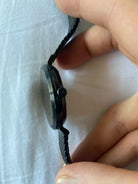 Close-up of Michael Kors MK8742 black analog dial with black Milanese mesh bracelet